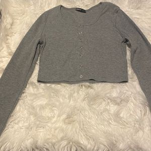 Crop top long sleeve shirt. Buttons down the middle does open.